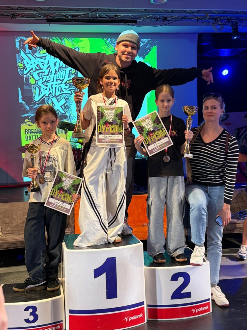 Laureaci na podium z pucharami, medalami i dyplomami